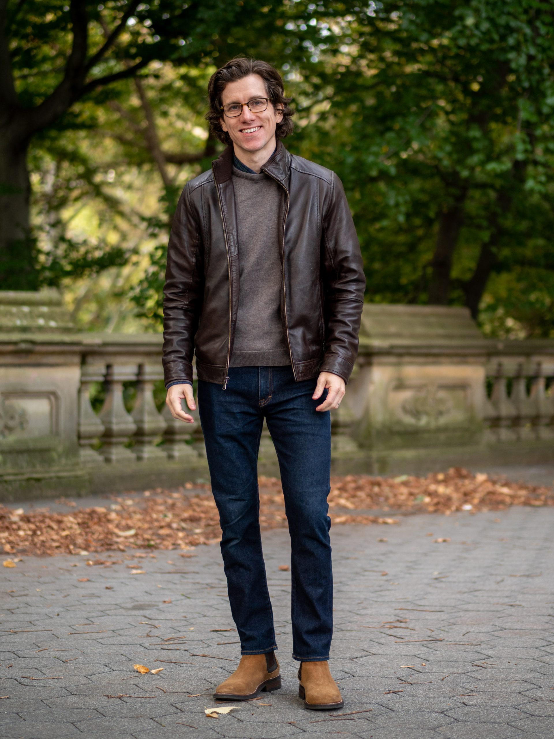 Leather jacket over sweater with jeans