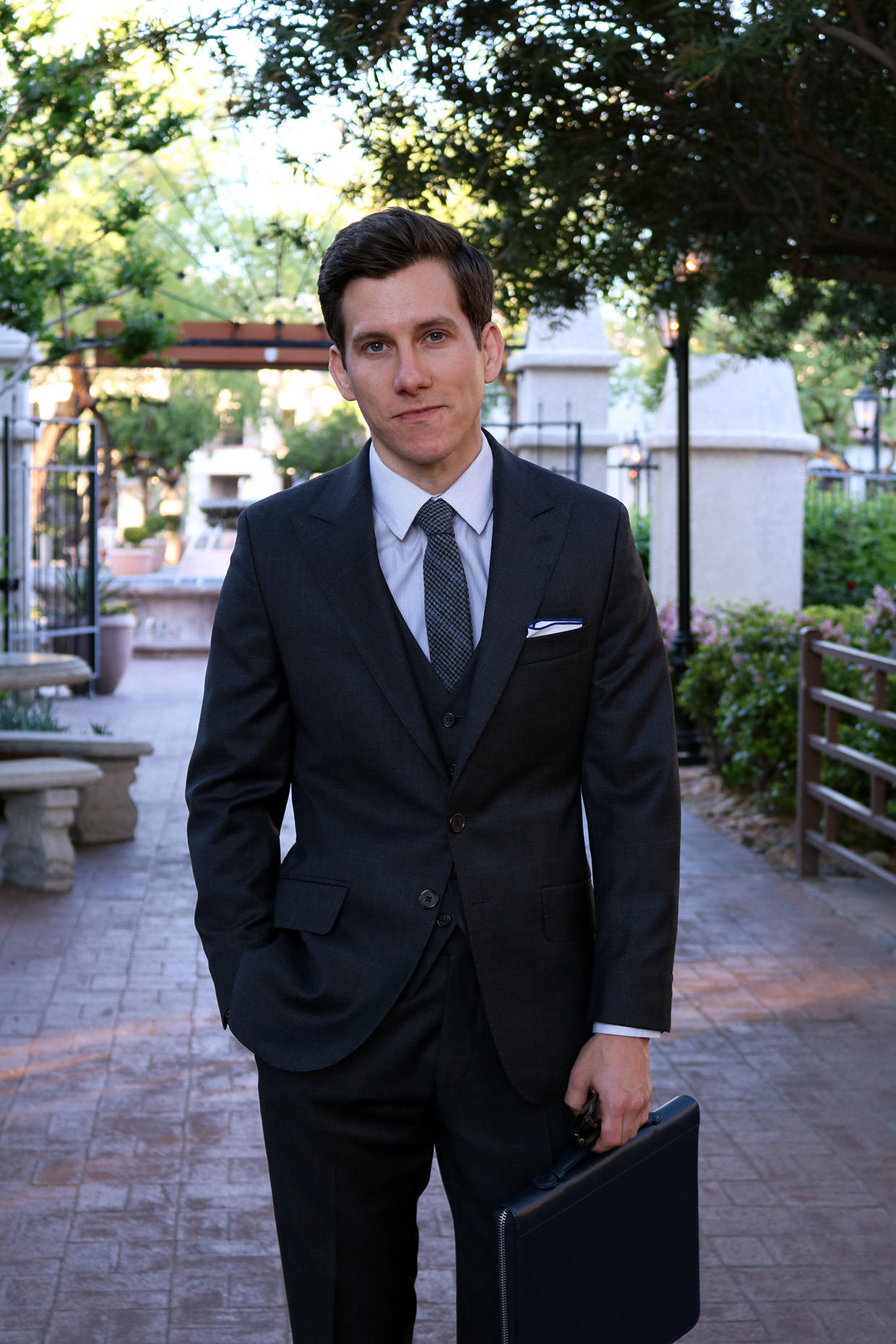 Short man wearing three piece suit