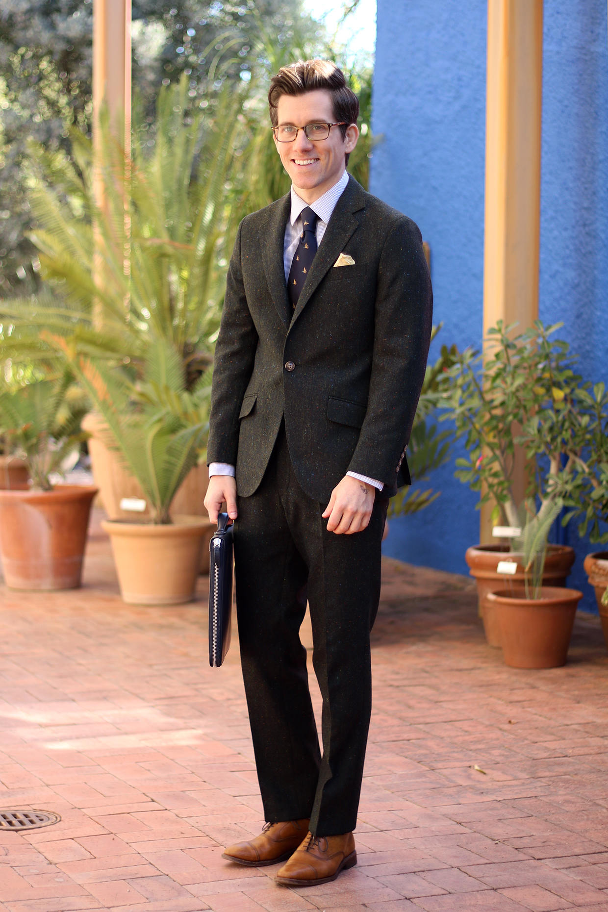 Green tweed suit with gold pocket square