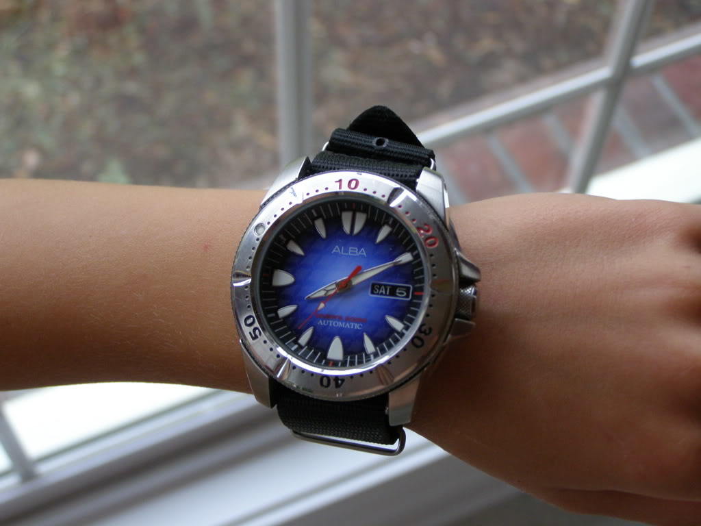 A much too big watch on a small wrist.