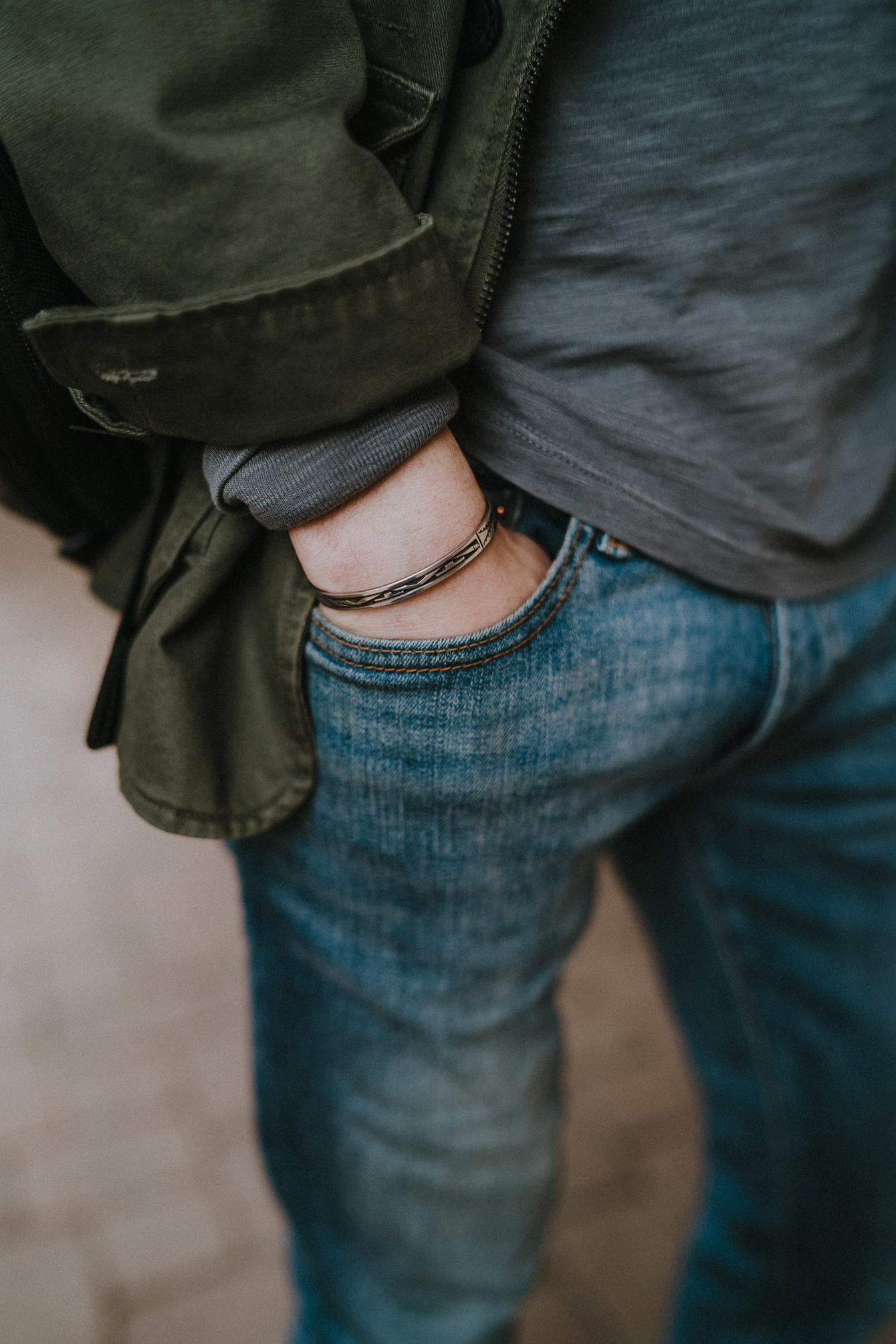 Hand in pocket silver bracelet