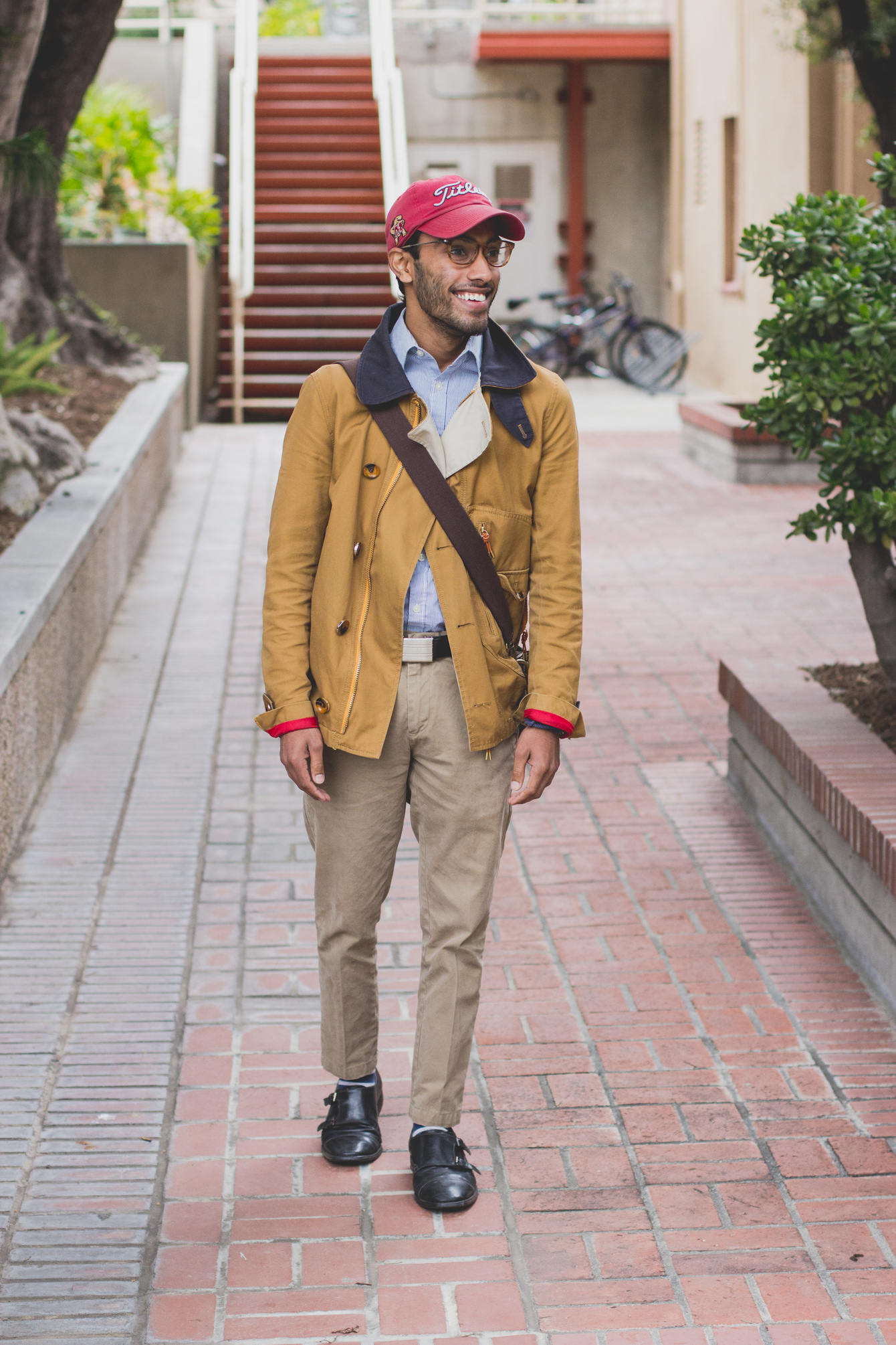 Rajesh wearing sky blue shirt, mustard yellow jacket and khaki pants