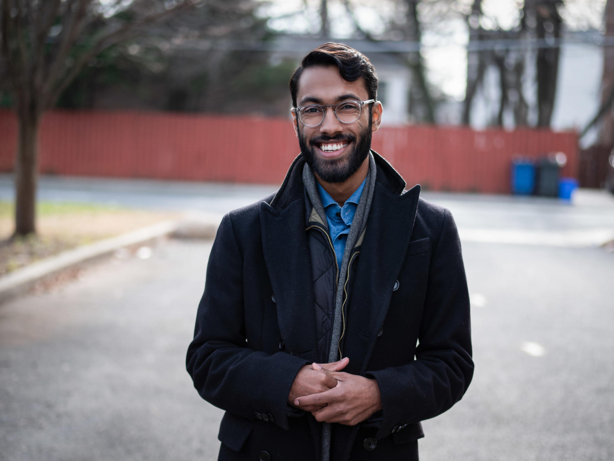 Rajesh wearing a wool topcoat