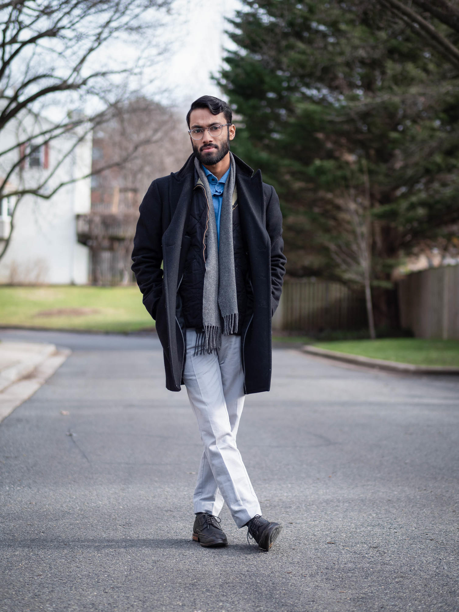 Rajesh wearing blue shirt, navy jacket and gray pants