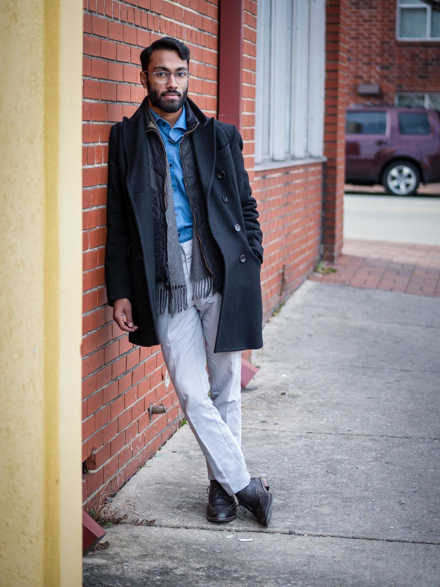 Rajesh wearing blue shirt, navy jacket and gray pants