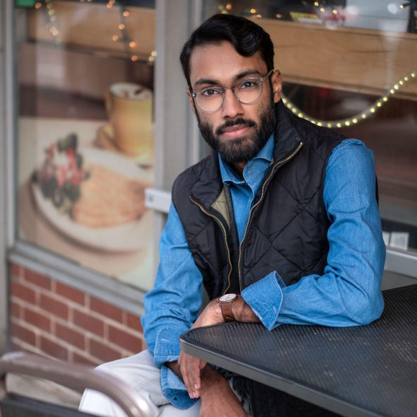 Rajesh wearing blue shirt and black vest