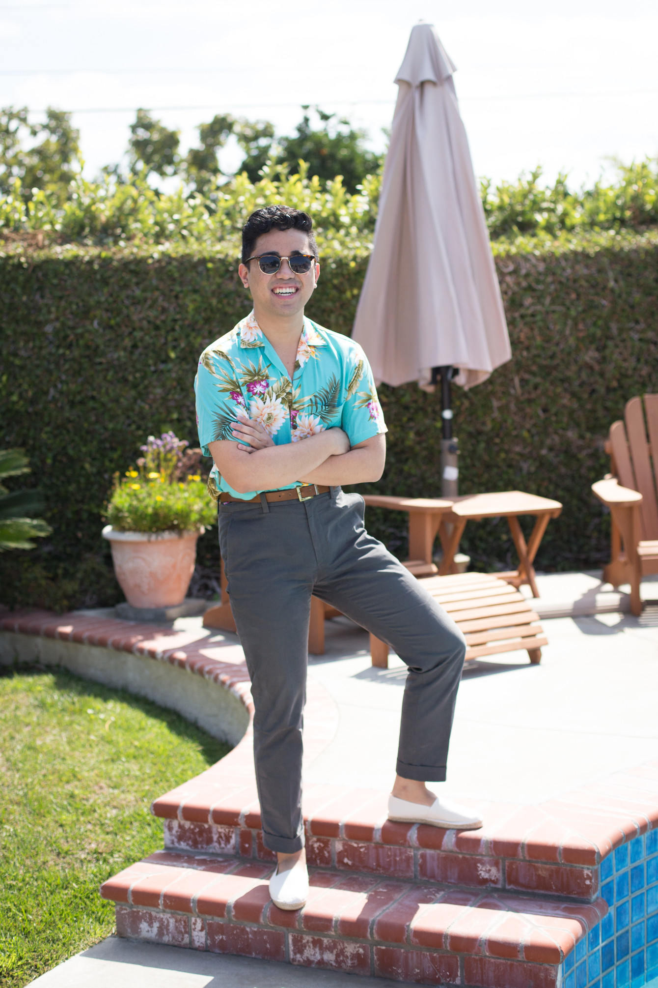 man wearing gray chinos and floral shirt