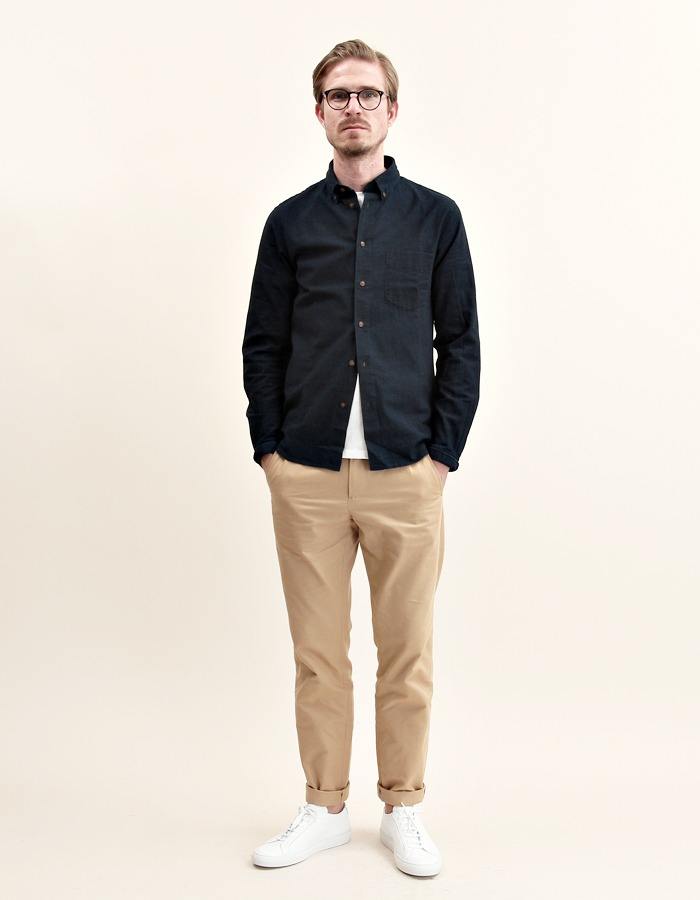 man wearing khaki chinos and black polo