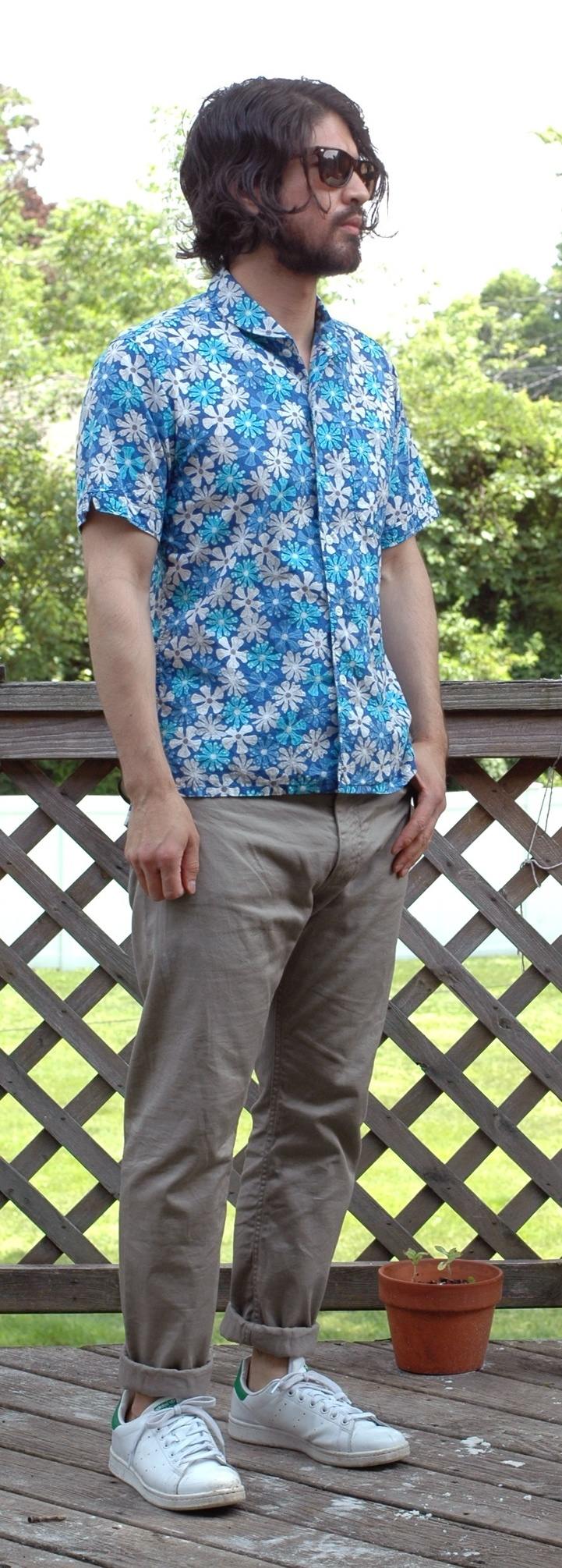 man wearing khaki chinos and floral shirt