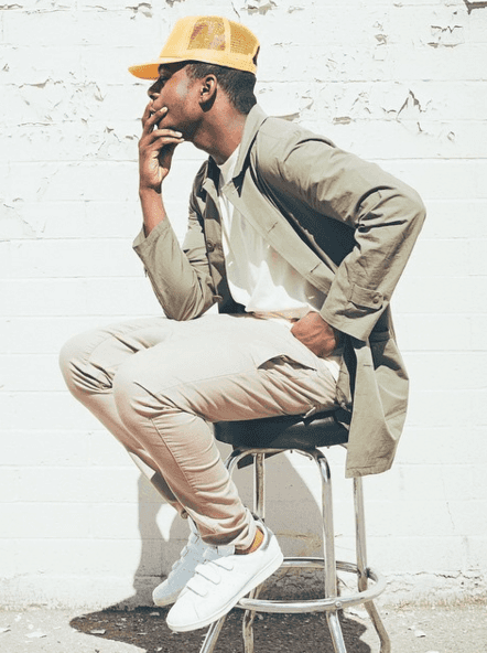 man wearing khaki chinos and white sneakers