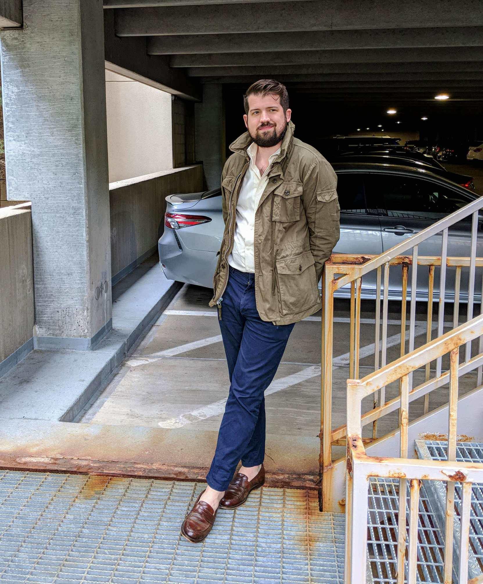 man wearing navy chinos and jacket