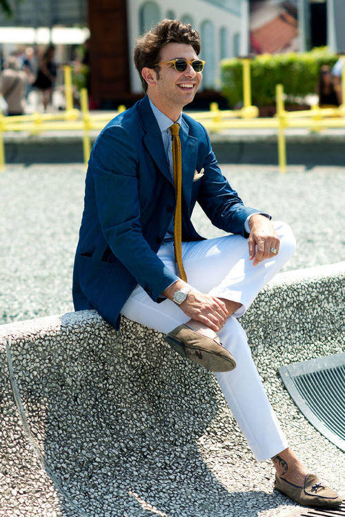 man wearing white chinos and coat