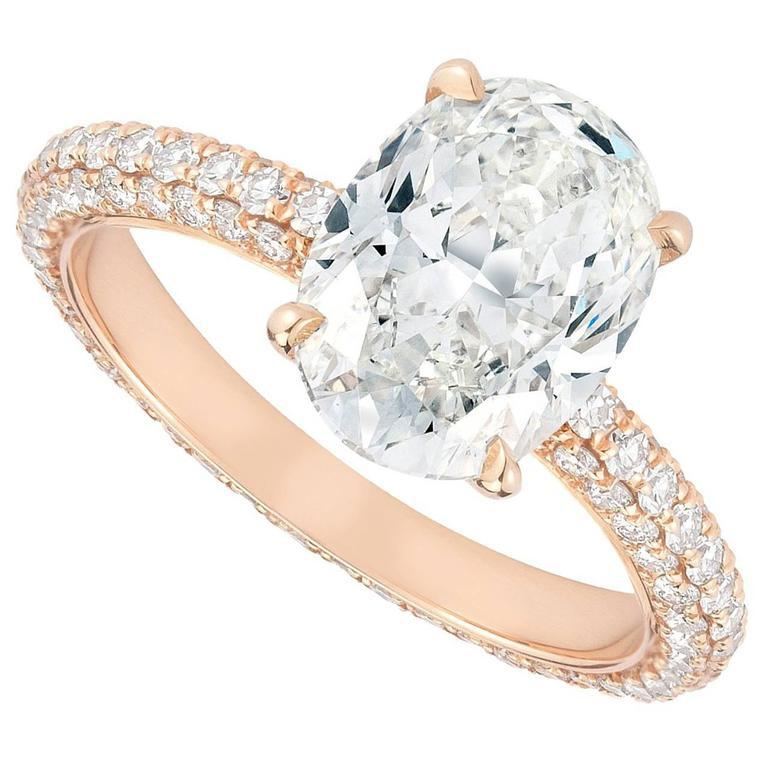 2.04 carat oval shaped diamond engagement ring with a micro- pavé band set in 18K rose gold.