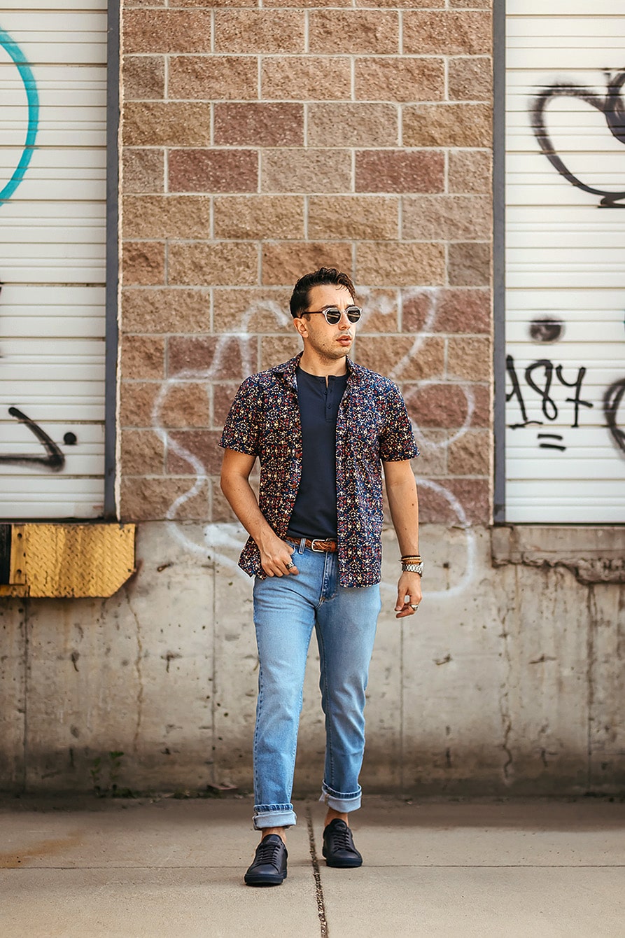 David wearing patterned shirt light wash jeans small