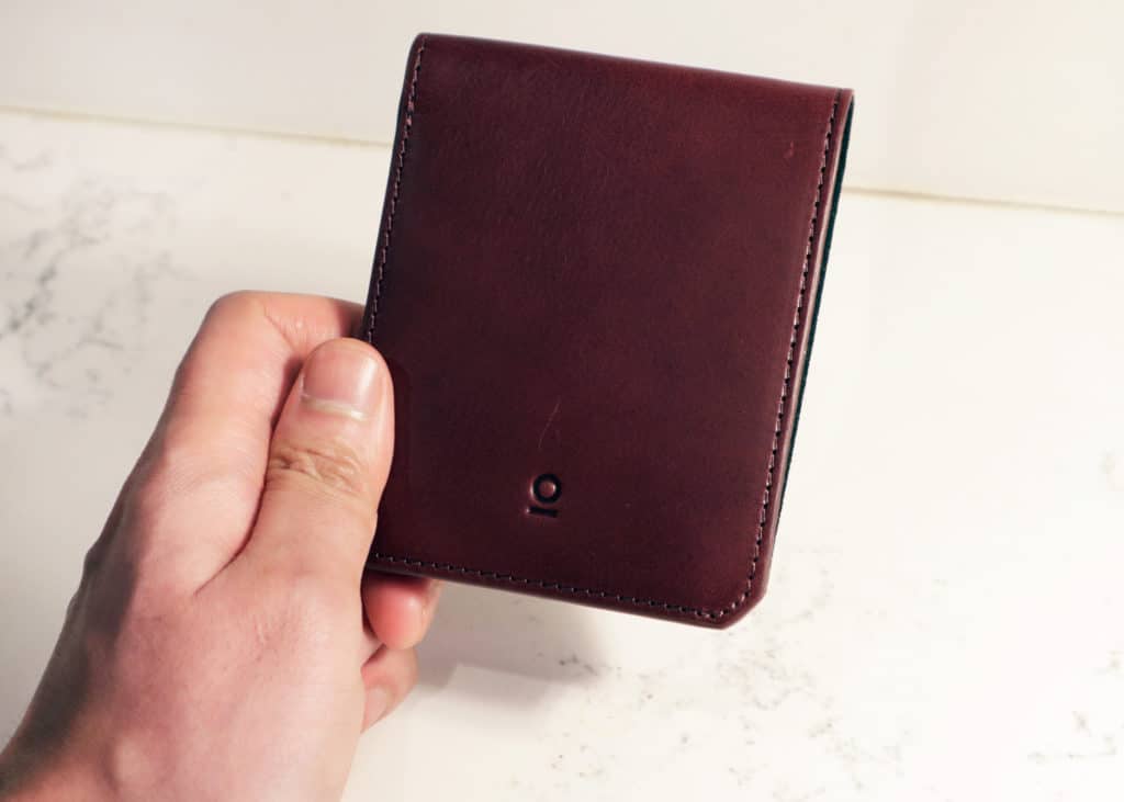 Stuart and lau oxblood slim wallet in hand