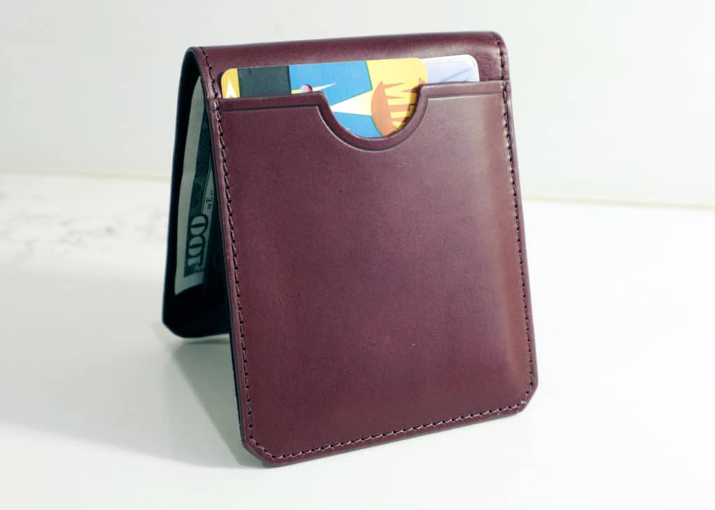 Stuart and lau oxblood slim wallet on table