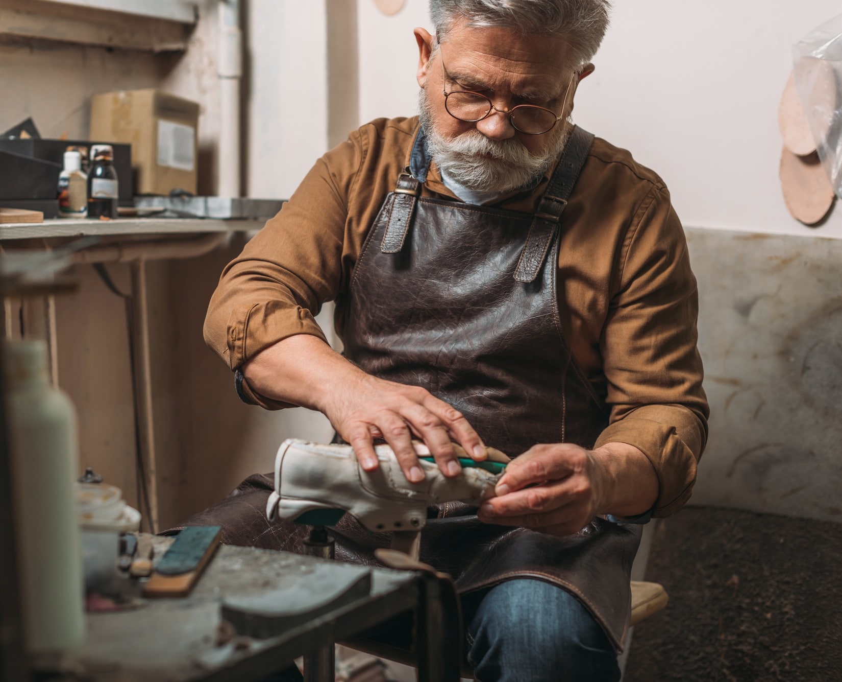 Cobbler repairing worn out shoes