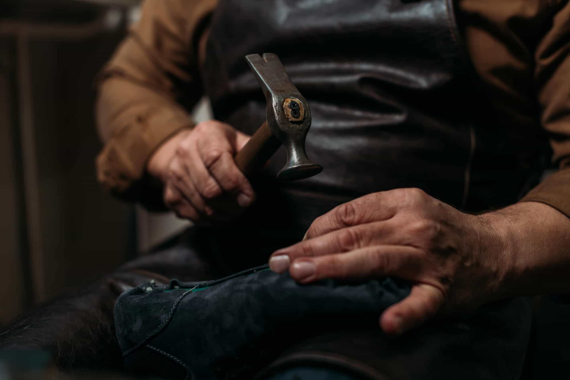 Holding hammer repairing shoes