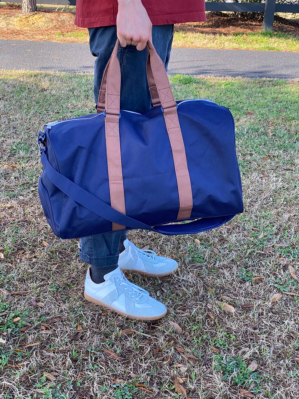 holding Herschel Duffel Bag