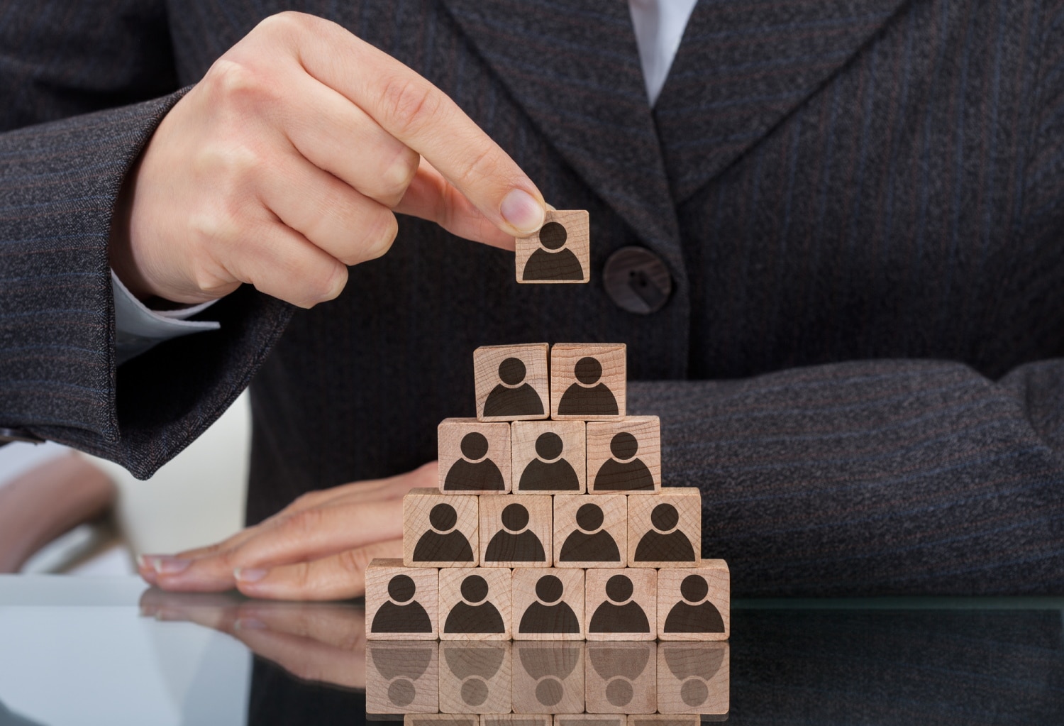 Businesswoman Stacking Wooden Team Blocks