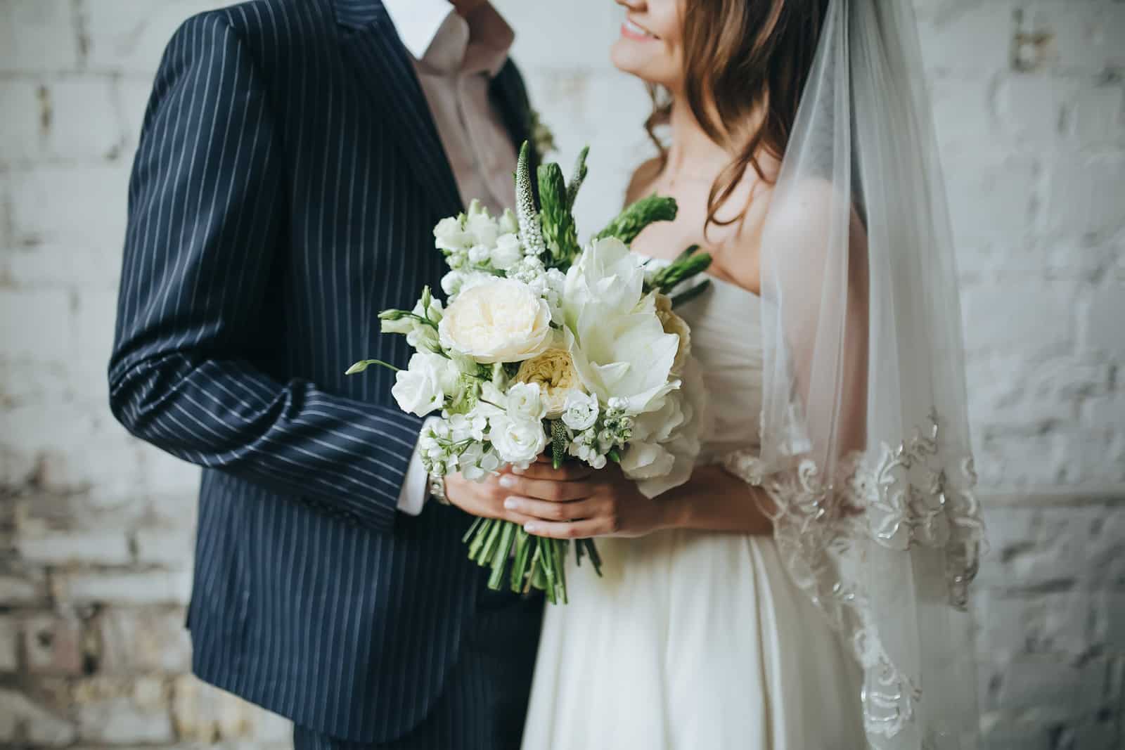 Bride and groom holding bouquet